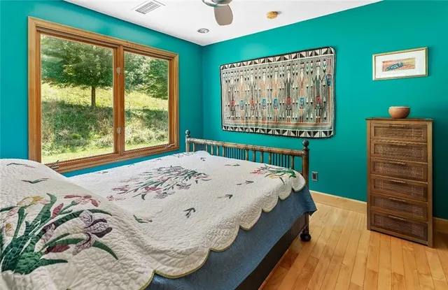 a bedroom with furniture and a wooden floor