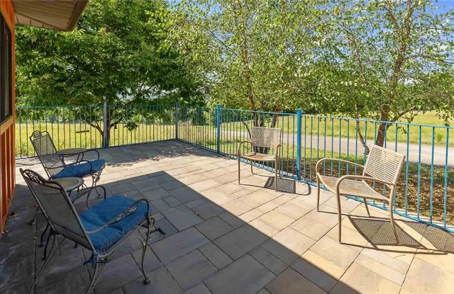 a view of a balcony with mountain view and wooden floor