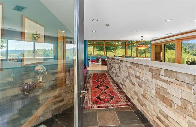 a living room with furniture and a floor to ceiling window