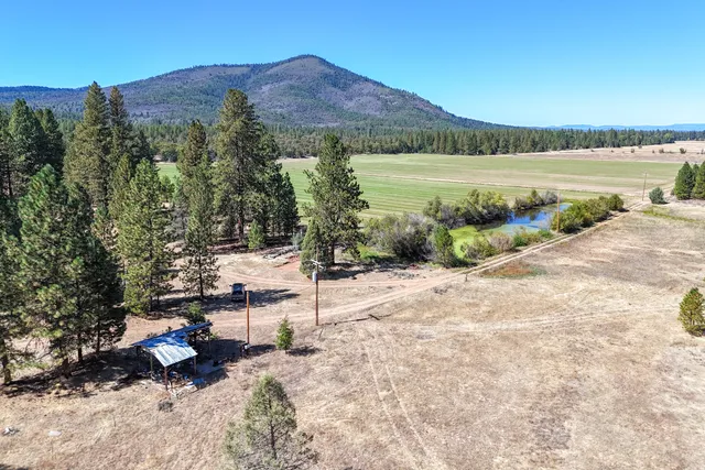 a backyard of a house with barbeque oven table and chairs