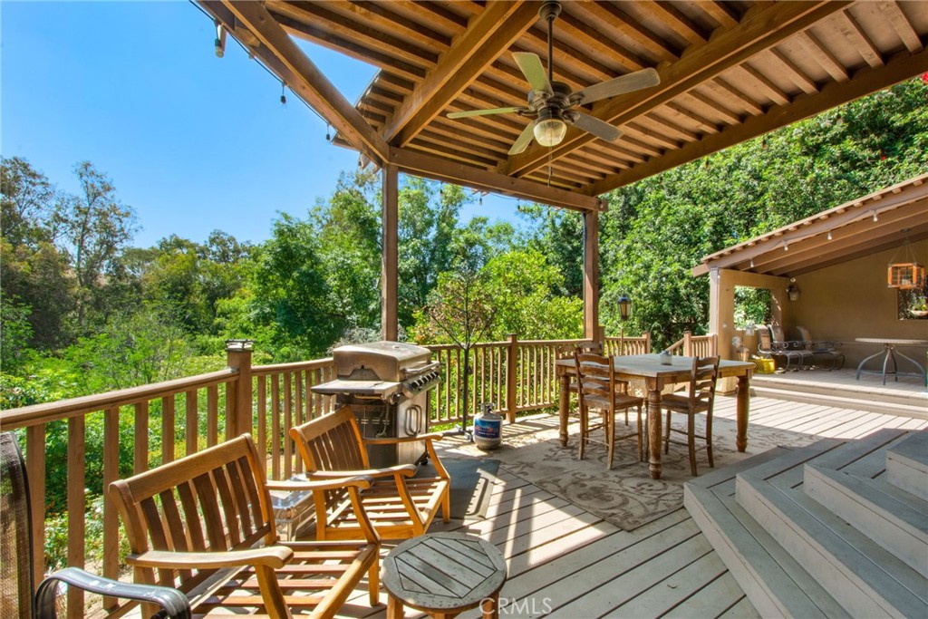 7241 Old Temescal Road Corona, CA 92881 - Photo 20 of 47 a view of a patio with table and chairs with wooden floor and fence