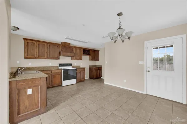a kitchen with stainless steel appliances granite countertop a stove sink and cabinets