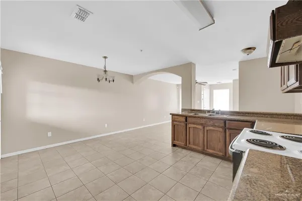 a large kitchen with kitchen island granite countertop white cabinets and a granite counter tops