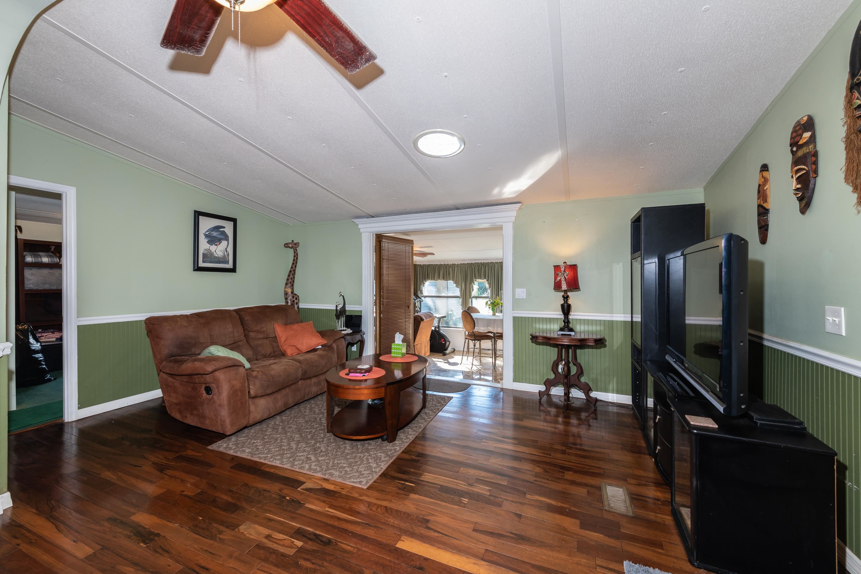 229 Barco Road St. Augustine, FL 32080 - Photo 8 of 46 a living room with furniture and a flat screen tv