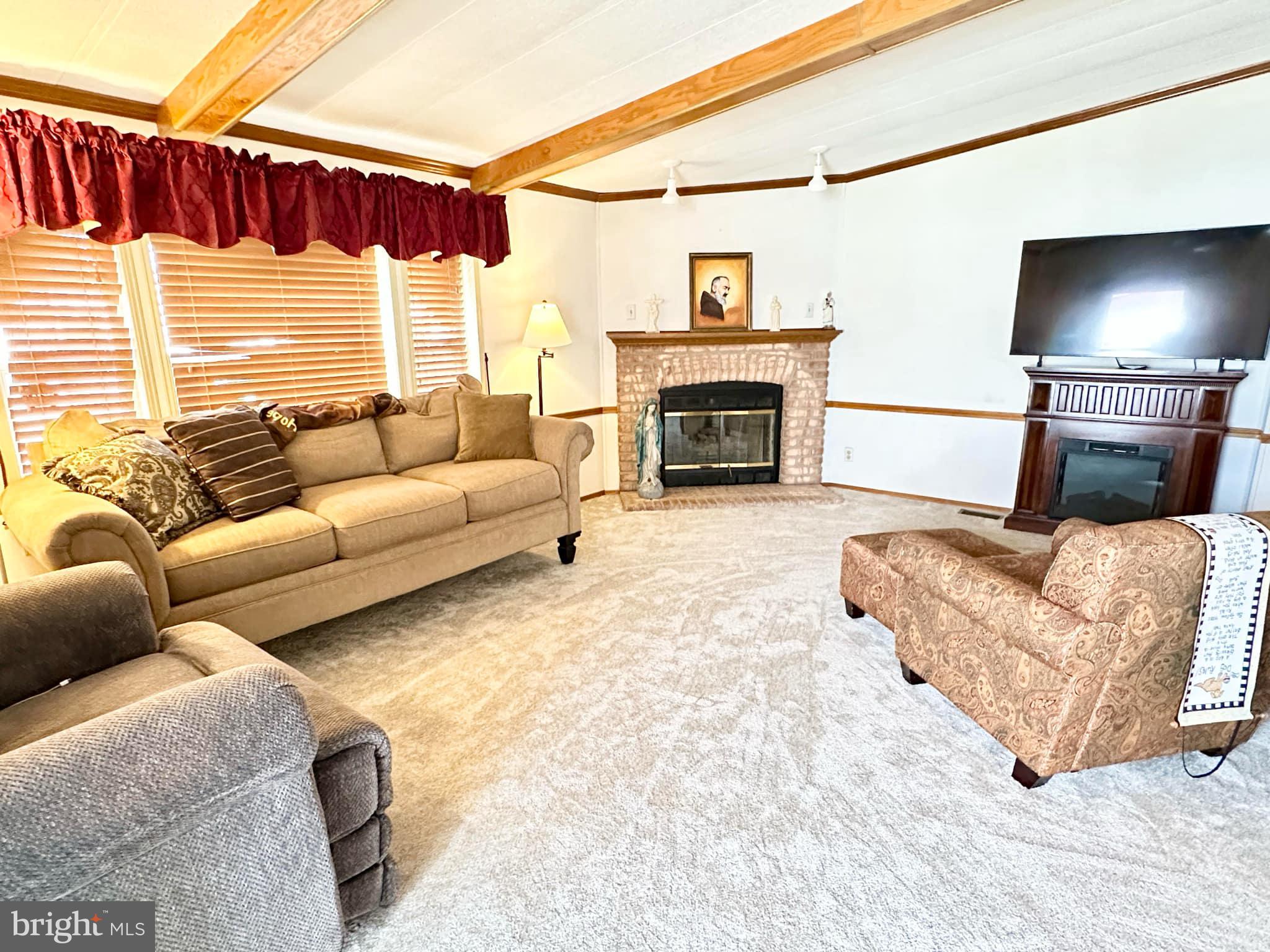 314 John Alden Drive Buena, NJ 08310 - Photo 11 of 23 a living room with furniture and a fireplace