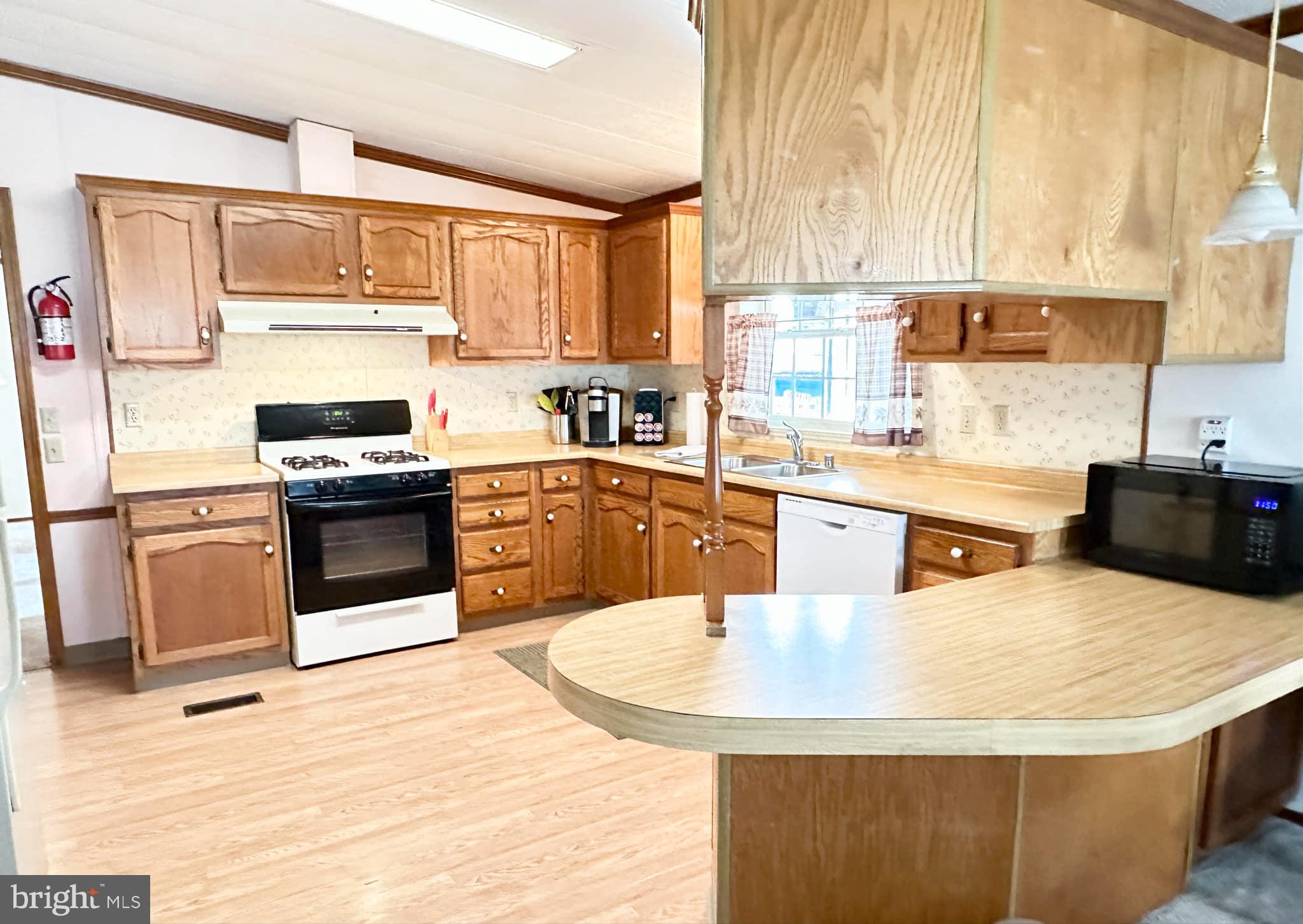 314 John Alden Drive Buena, NJ 08310 - Photo 13 of 23 a kitchen with stainless steel appliances kitchen island granite countertop a sink a stove and refrigerator