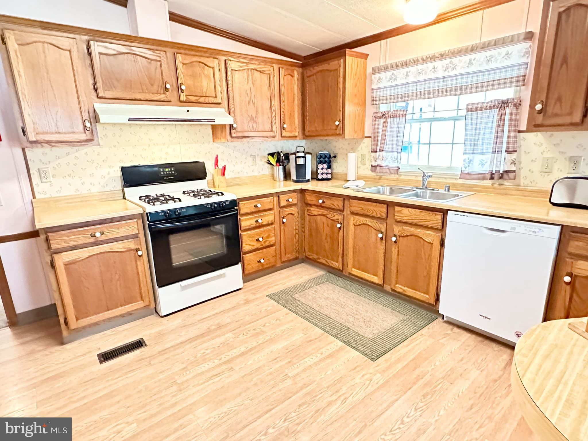 314 John Alden Drive Buena, NJ 08310 - Photo 15 of 23 a kitchen with granite countertop a sink stainless steel appliances and cabinets