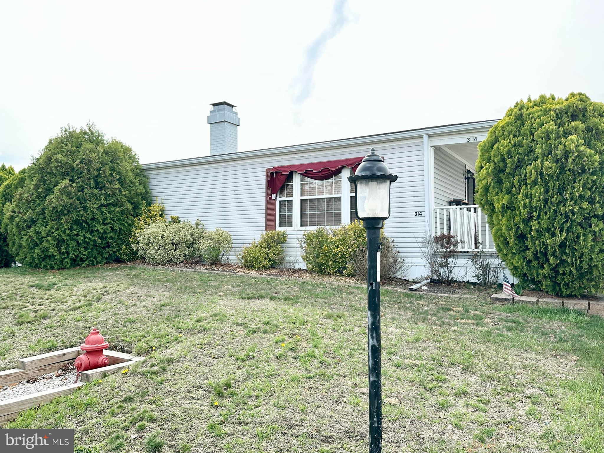 314 John Alden Drive Buena, NJ 08310 - Photo 2 of 23 a front view of a house with a yard
