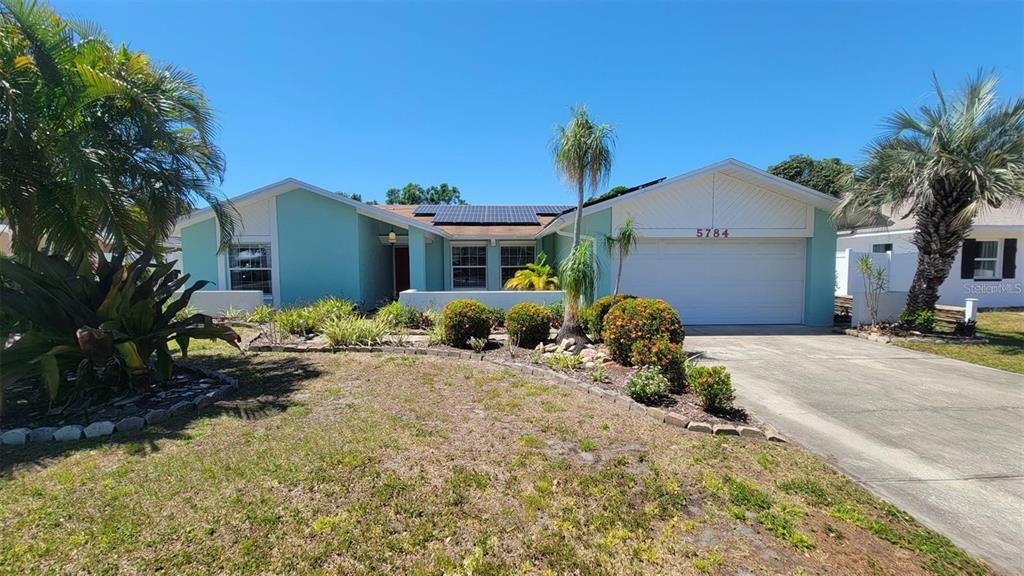 Undisclosed Address St. Petersburg, FL 33708 - Photo 1 of 11 a front view of a house with a yard