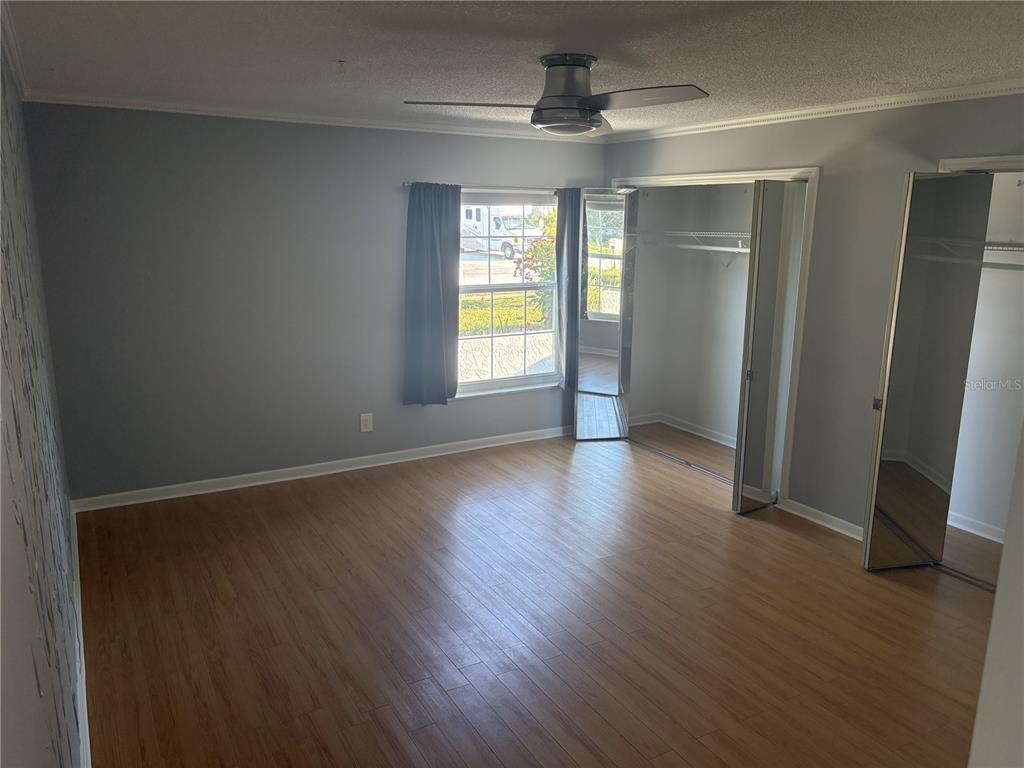 Undisclosed Address St. Petersburg, FL 33708 - Photo 2 of 11 an empty room with wooden floor and windows