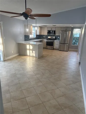 a kitchen with stainless steel appliances granite countertop a stove a sink and a refrigerator