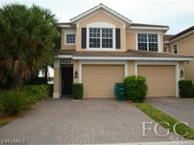 2623 Somerville Loop, Unit 508 Cape Coral, FL 33991 - Photo 1 of 10 front view of a house with a yard