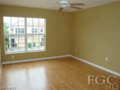 2623 Somerville Loop, Unit 508 Cape Coral, FL 33991 - Photo 5 of 10 a view of an empty room with a window and wooden floor