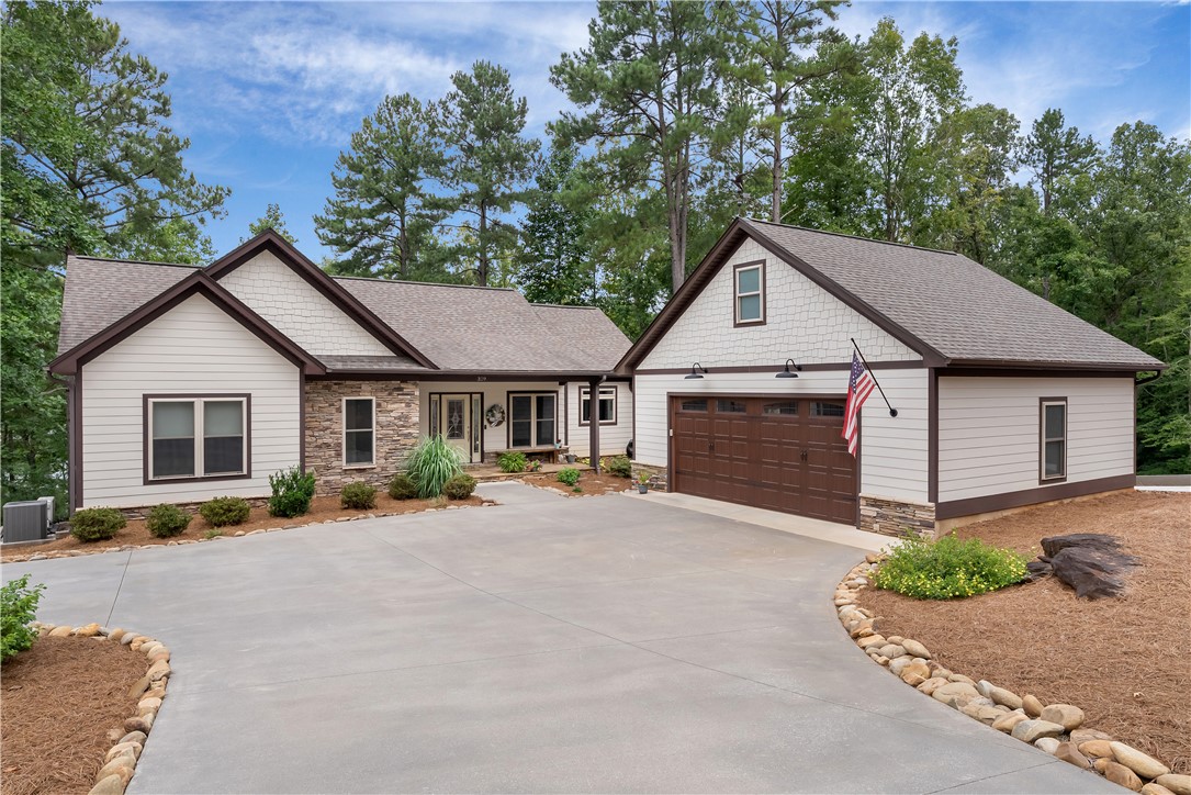 329 High Hampton Road Salem, SC 29676 - Photo 19 of 47 Stone accents and shake siding complement this modern ranch exterior with an attached garage.