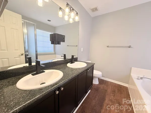 a bathroom with a sink double vanity and a mirror