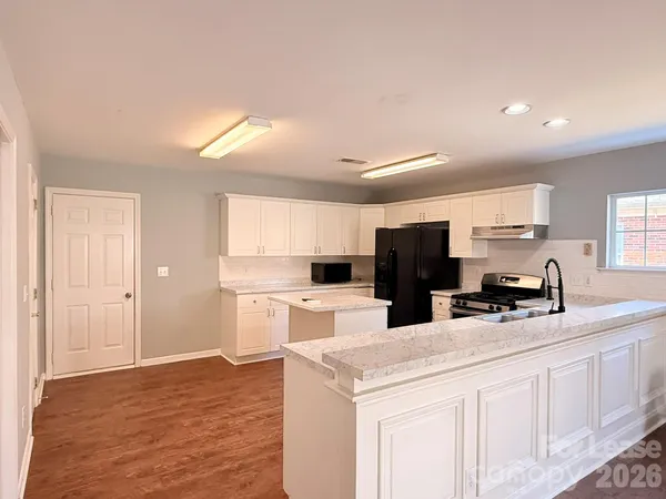 a kitchen with refrigerator and cabinets