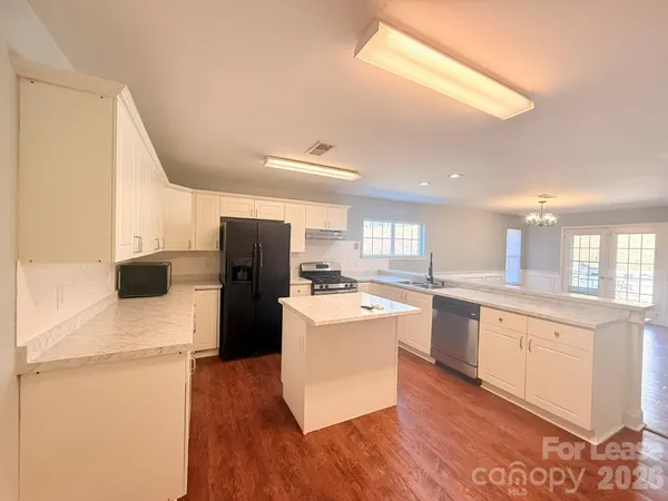 a kitchen with a sink a stove a refrigerator and a refrigerator