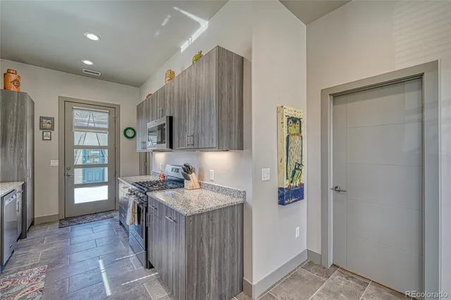 a kitchen with stainless steel appliances granite countertop a refrigerator and a sink