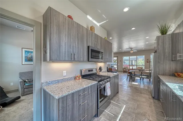 a kitchen with a stove a sink and a refrigerator