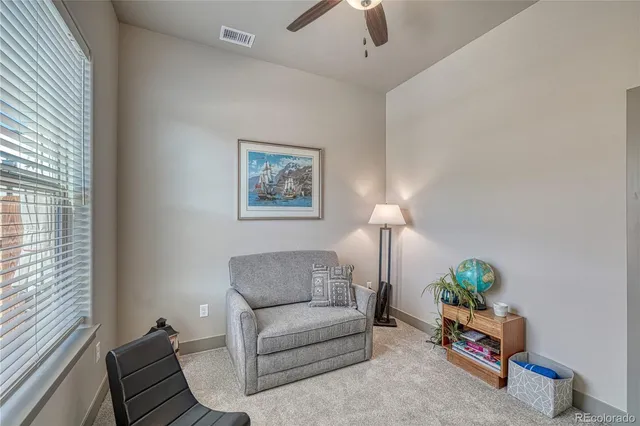 a living room with furniture and a potted plant