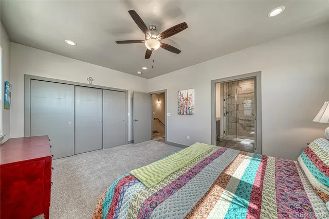 a bedroom with a large bed and a chandelier
