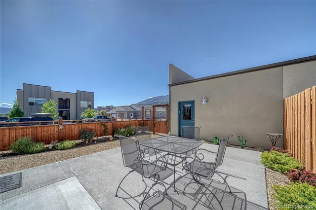 a backyard of a house with sitting area and outdoor seating
