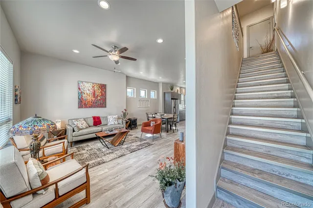 an outdoor living space with furniture and wooden floor