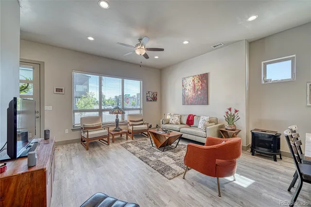 a living room with furniture wooden floor and a flat screen tv