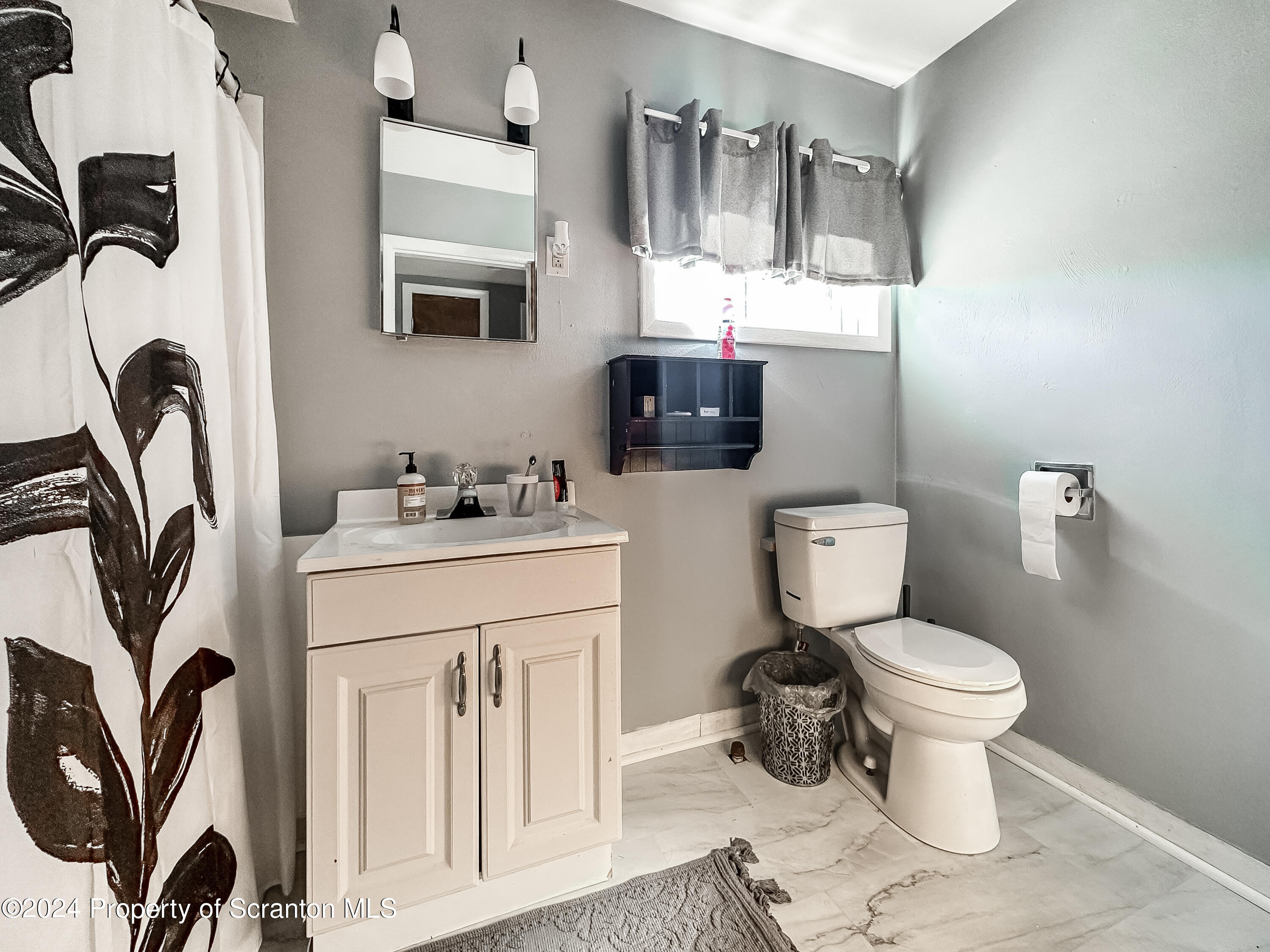218 Hand Street Jessup, PA 18434 - Photo 16 of 32 a bathroom with a toilet sink and mirror
