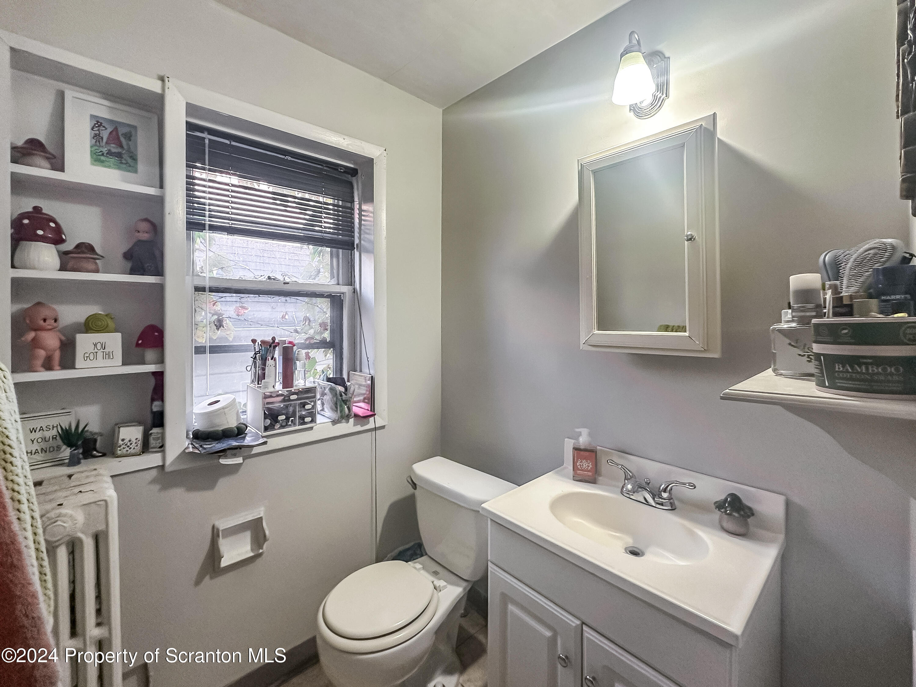 218 Hand Street Jessup, PA 18434 - Photo 23 of 32 a bathroom with a toilet sink and mirror