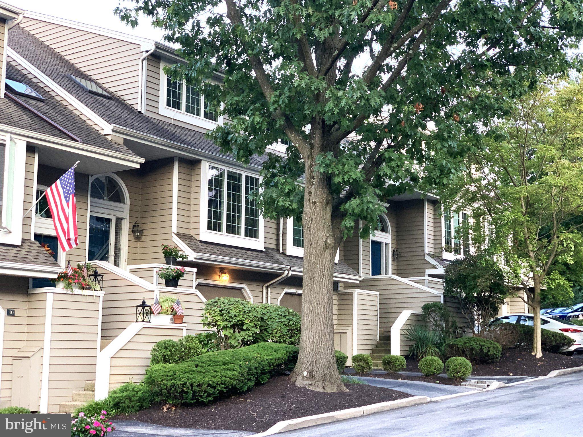 Charming townhomes with lush greenery.