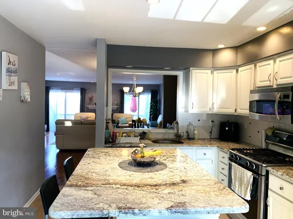 a kitchen with sink refrigerator and stove