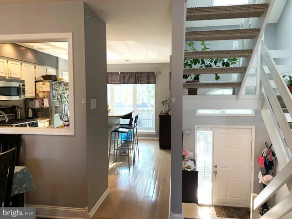 a hallway with a view of living room with furniture