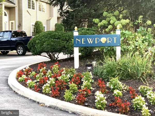 a sign that is sitting in front of flowers