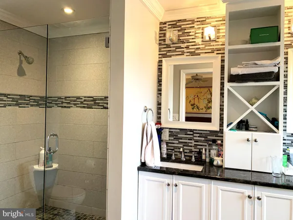 a view of a bathroom with a shower and a sink