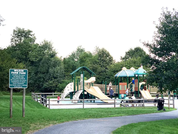 a childrens park with lots of swings and slides