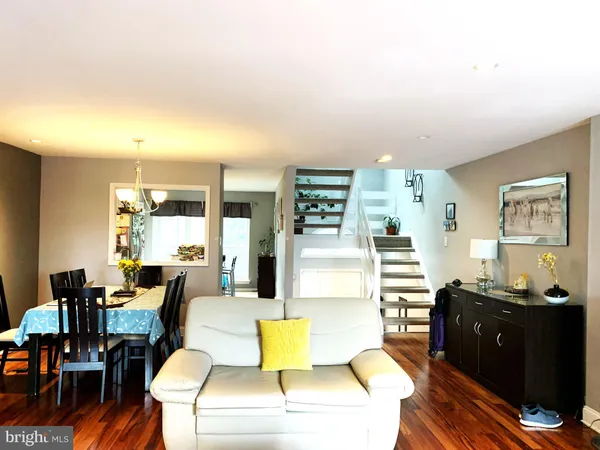 a living room with fireplace furniture and wooden floor