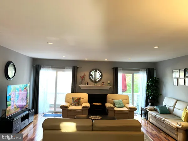 a living room with fireplace furniture and a flat screen tv