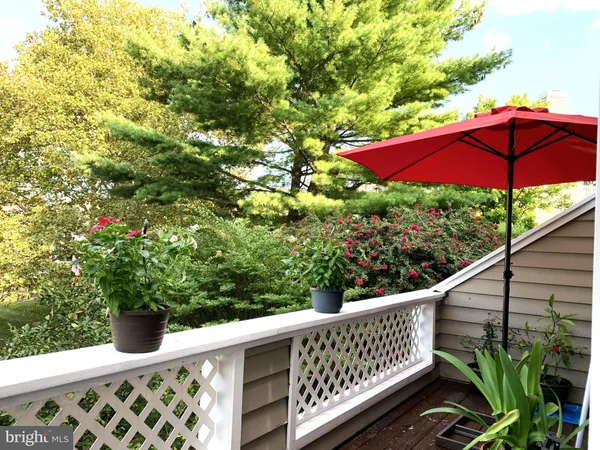 a view of a wooden deck with chairs and wooden fence