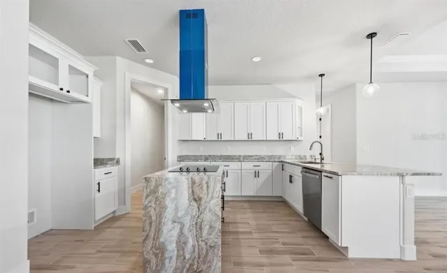 a kitchen with a stove a sink and a refrigerator