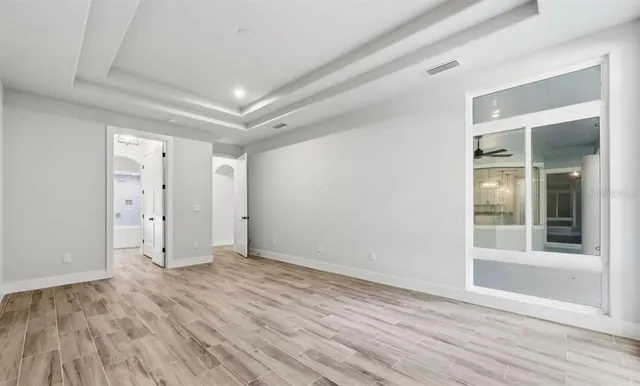 a bathroom with a granite countertop sink a large mirror and shower