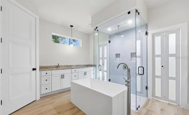 a bathroom with a granite countertop sink a toilet and shower