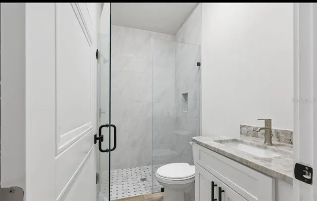 a view of an house with backyard and porch