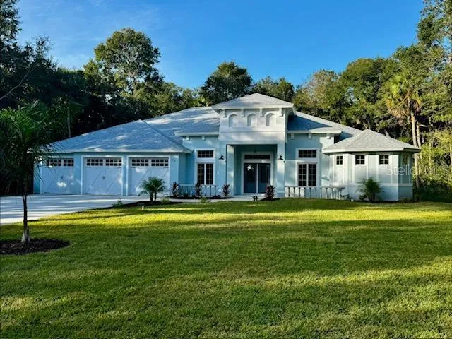 a front view of a house with swimming pool having outdoor seating