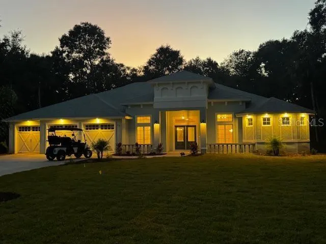 a backyard of a house with lots of green space and fountain