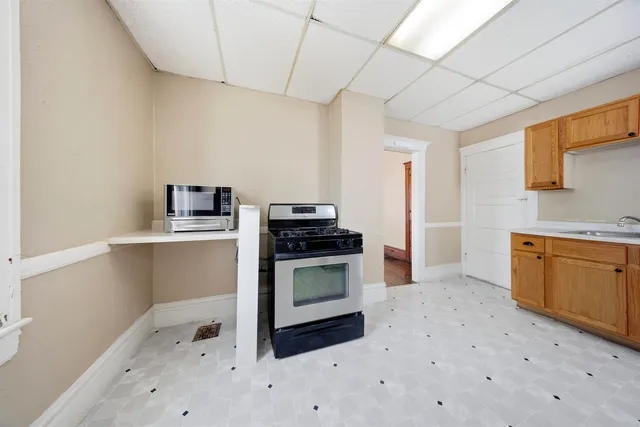 a kitchen with granite countertop a stove and a sink