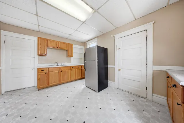 a kitchen with a refrigerator and a sink