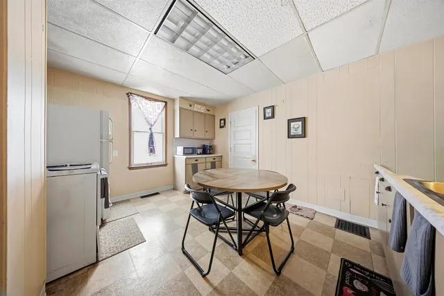 a view of a dining room with furniture and window