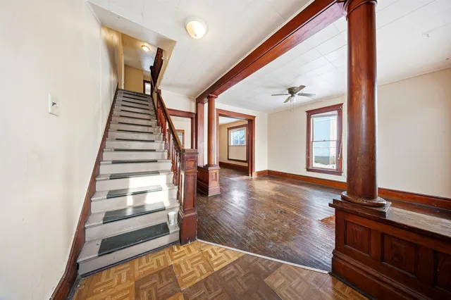 a view of an entryway with wooden floor