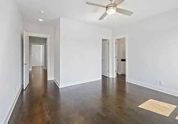 a view of an empty room and wooden floor